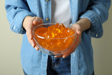 Woman hold bowl of delicious orange jelly