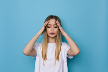 Young Woman Has A Headache And Is Holding Her Head In Her Hands