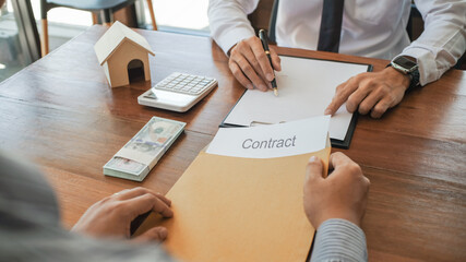 Business people negotiating for sign  contract. buy sell real estate contract.Business concept and contract signing.