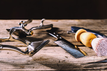 old barber tools on rustic wooden weathered background