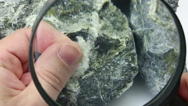 Asbestos mineral fiber in human fingers, close-up.