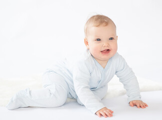 Happy adorable pensive baby plays on a floor,