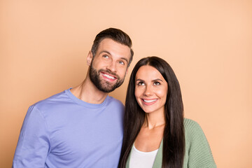 Obraz premium Photo of optimistic nice couple look empty space wear sweater isolated on beige color background