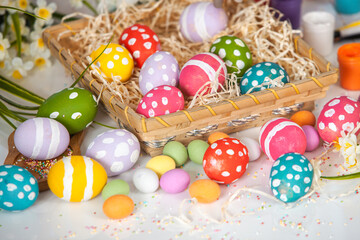 Fototapeta na wymiar Hand painted pastel colored Easter eggs background. Happy Easter greeting card or invitation.