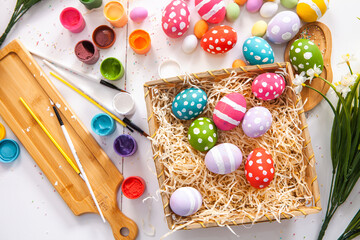 Hand painted pastel colored Easter eggs background. Happy Easter greeting card or invitation.