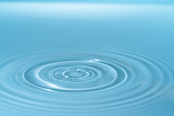 Waves on the surface of the water from a collision. Drop of water drop to the surface.