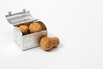 Champagne corks in a small vintage metal chest. Isolate on a white background.