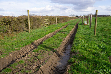 Fototapeta na wymiar Deep rutted muddy farm track