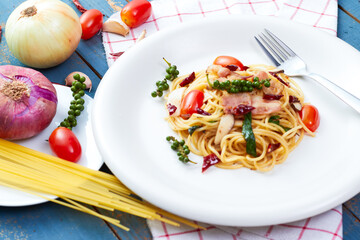 Spicy spaghetti bacon sauce with ingredient homemade on the wooden table.