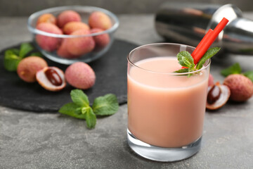 Lychee cocktail on grey table, space for text
