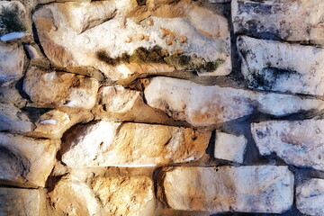 A fragment of an old ruined wall. Retro. Masonry. Tinted frame. Horizontally. Grunge.