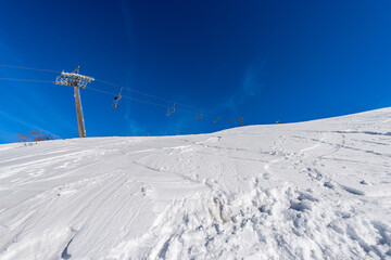 Empty Chairlift in snowy winter landscape. Malga San Giorgio ski resort. Altopiano della Lessinia (Lessinia Plateau), Regional Natural Park, Verona province, Veneto, Italy, Europe.