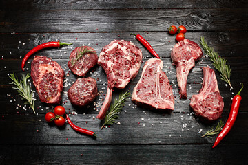 Set of various raw dry-aged steaks meat, veal beef steaks - ribeye, filet mignon, tomahawk,...