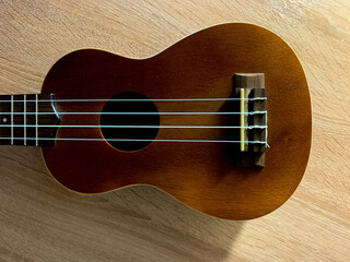Small guitar on the wood background