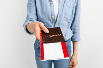 Fototapeta na wymiar happy young woman holding travel tickets and passport on white background