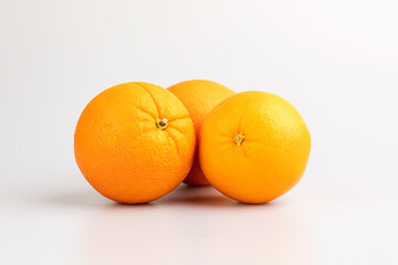 An orange in fruit with full and a half showing in isolated background.