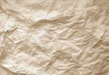 Crumpled brown paper sheet surface.