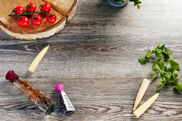 light wooden background with greens corn and tomatoes