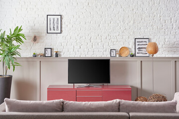 Television unit is in the living room, close up sofa and white brick wall concept.