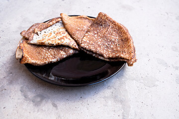 A few pancakes on a light grey background. Top view. Flat lay.