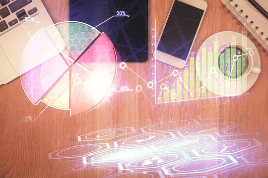 Multi exposure of forex graph hologram over desktop with phone. Top view. Mobile trade platform concept.