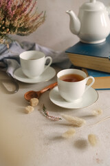 Still life with tea, books and flowers