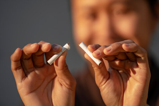 Beauty woman happy to breaking a cigarette. Wold tobacco day and  quit smoking cigarettes concept