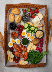 Fototapeta na wymiar Charcuterie breakfast or brunch board on a tray, cutlery