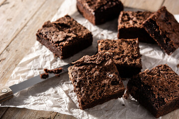 Homemade pieces of brownies on wooden table