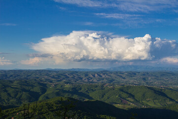 A large beautiful cloud over the expanse of western Serbia. View from Mount Kablar.