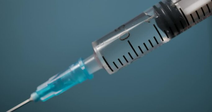 Close Up of Injection Liquid Being In Syringe Against Red Background. Medication Drug Needle Syringe Drug, Flu Shot Vaccine Vial Dose Hypodermic Injection Treatment Disease Prevention Immunization.