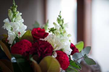 Close up of bouquet of flowers to a loved one in a glass vase