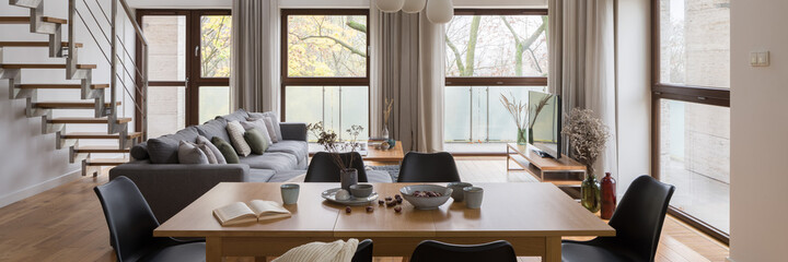 Dining table in spacious living room, panorama