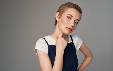 Obraz premium Woman with short hair Makeup on her face gray background