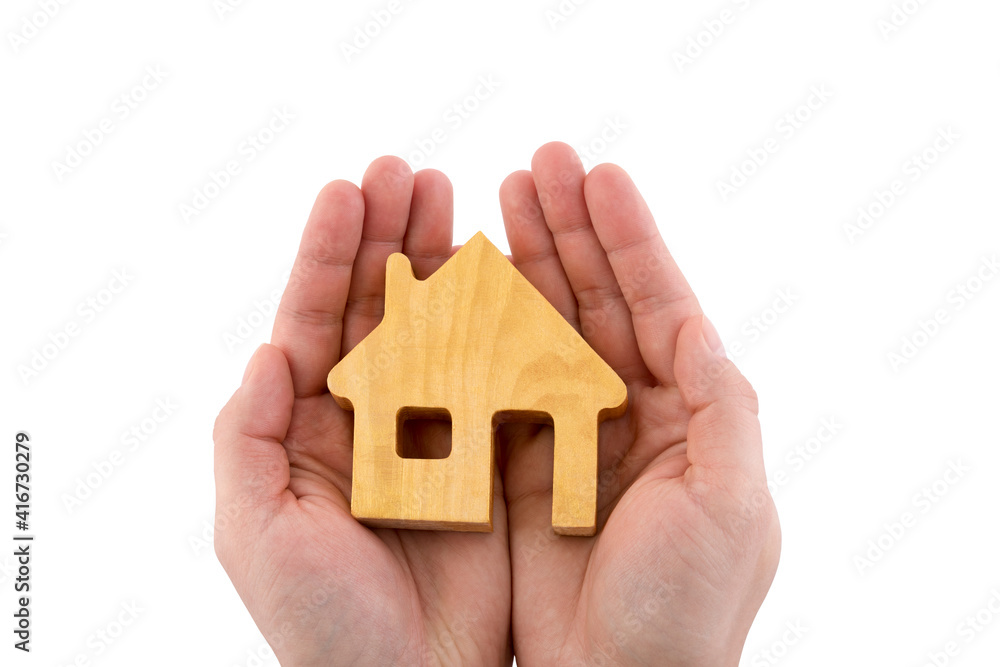 Poster Wooden house shape in hands isolated on white with clipping path