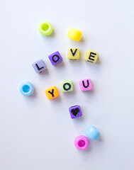 the inscription I love you made of colorful beads