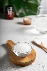 selective focus. Collagen powder in a glass container. light background. copyspace. Extra protein...