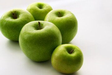 Ripe green apples on a white window. Juicy fruits on a white background.