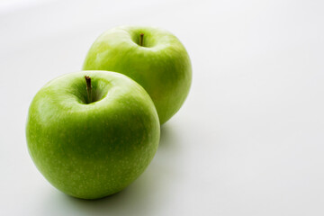 Ripe green apples on a white window. Juicy fruits on a white background.