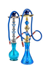 Fototapeta na wymiar Two hookahs shishas with blue glass flask and metal bowl on a white background.