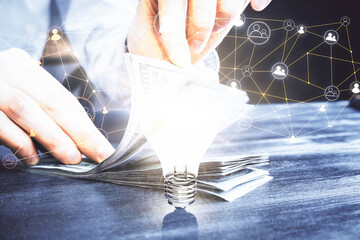 Multi exposure of social network theme drawing hologram and USA dollars bills and man hands.