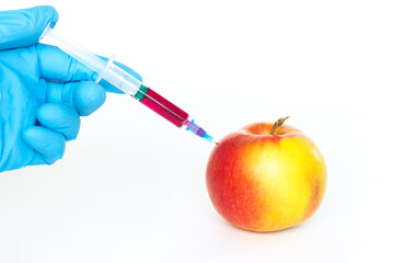 Red and yellow apple and syringe with nitrates isolated on a white background. Pesticides and...