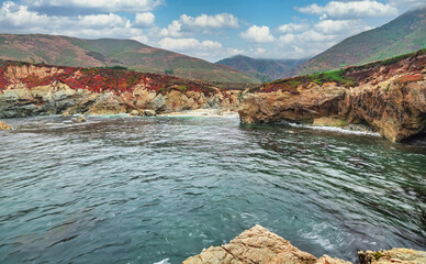 A beautiful view of a small cove in the Pacific Ocean, California, colorful landscape, bright sunny weather.