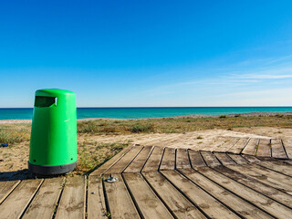 Empty beach with trash can