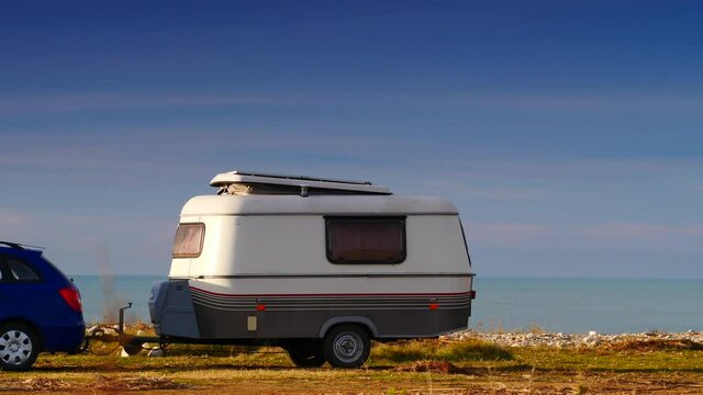 Caravan trailer wild camping on seashore. Capicorb, Valencia region Spain. Travelling, vacation with mobile home.