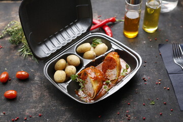 Takeaway food in a box. Ready prepared meal in a box. Tasty catering delivered to the office.