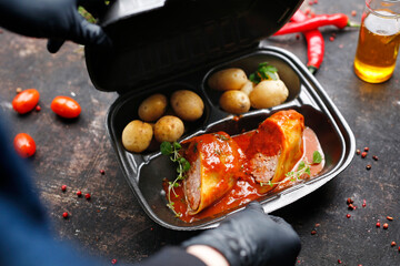 Takeaway food in a box. Ready prepared meal in a box. Tasty catering delivered to the office.