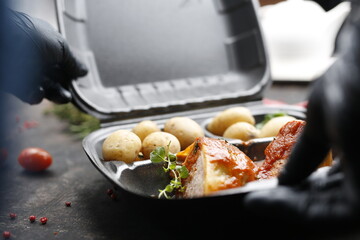 Takeaway food in a box. Ready prepared meal in a box. Tasty catering delivered to the office.