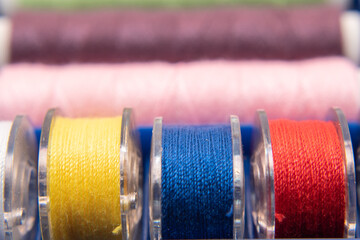 image of different colored sewing threads and sewing tools - obrazy, fototapety, plakaty