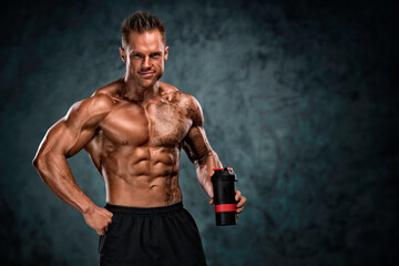 Fototapeta na wymiar Protein Drink. Muscular Men Holding Nutritional Supplement Drink In His Hand